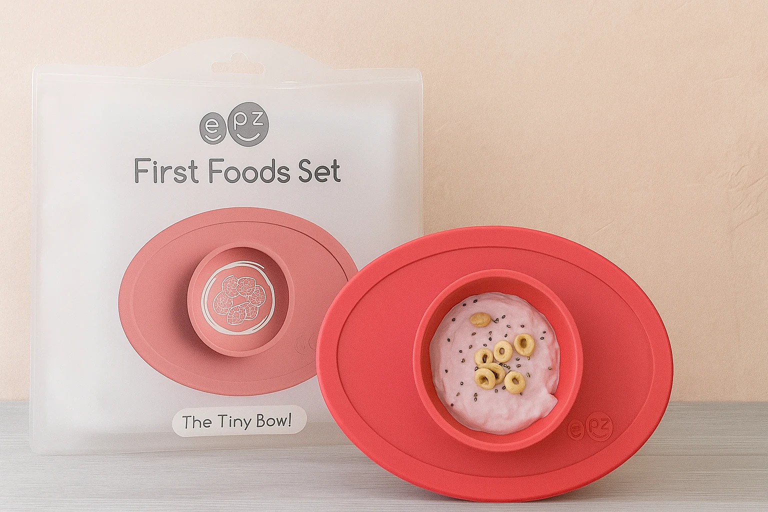 eZpz First Foods Set with coral silicone Tiny Bowl and transparent packaging on wooden surface